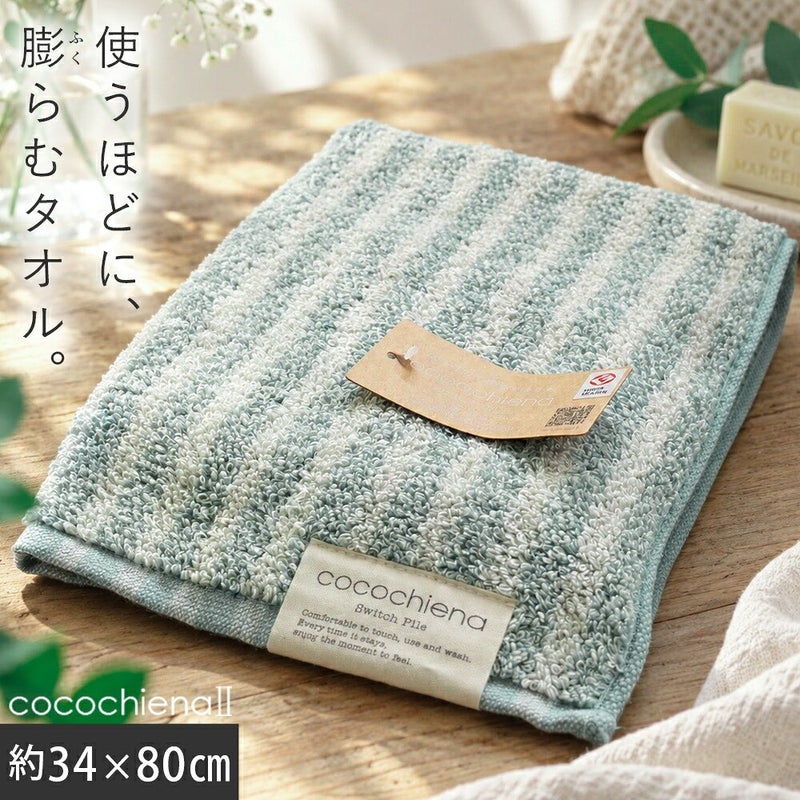cocochiena2 フェイスタオル カラー:ライン柄/ブルー を畳んで木製テーブルに置いた商品写真（約34×80cm）