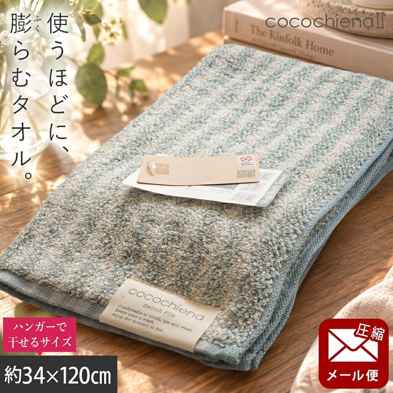 cocochiena2 スリムバスタオル【メール便】 カラー:ライン柄/ブルー を畳んで木製テーブルに置いた商品写真（約34×120cm）